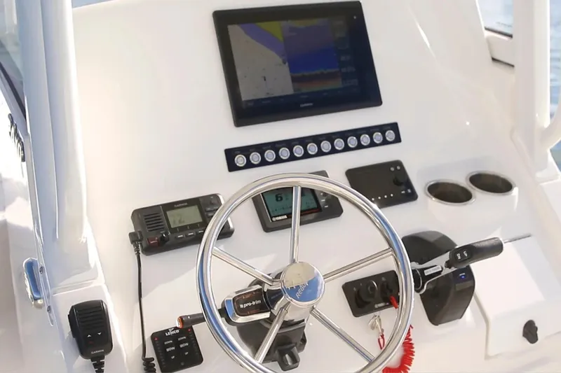 Slide: The Image of Helm of 2027 Regulator 24XO boat with modern navigation equipment and controls. - 3