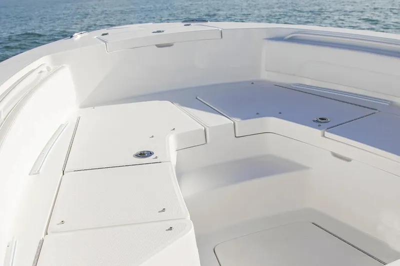 Slide: The Image of 2027 Regulator 24XO boat interior with sleek seating and storage, on calm water. - 5