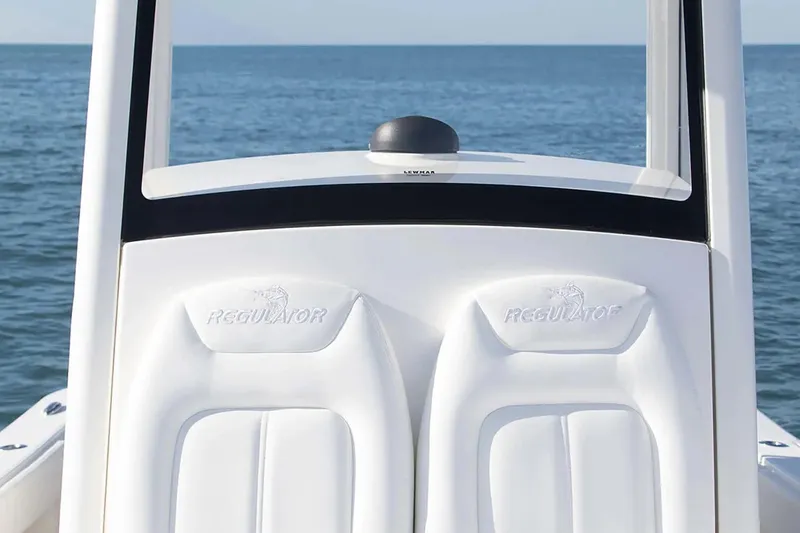 Slide: The Image of 2027 Regulator 24XO boat seats with logo, ocean backdrop. - 7