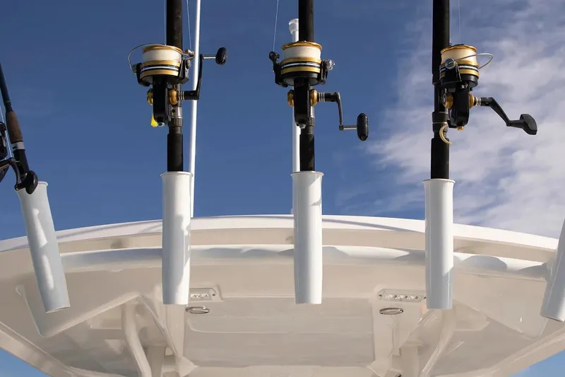 Slide: The Image of Fishing rods on a 2027 Regulator 24XO boat against a clear blue sky. - 9