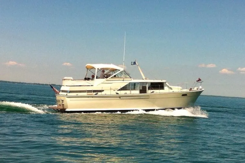 The Image of 1971 Chris-Craft 42 Commander yacht cruising on open water under clear skies. - 0