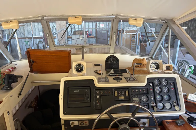 Slide: The Image of 1971 Chris-Craft 42 Commander helm with gauges, controls, and navigation equipment. - 11