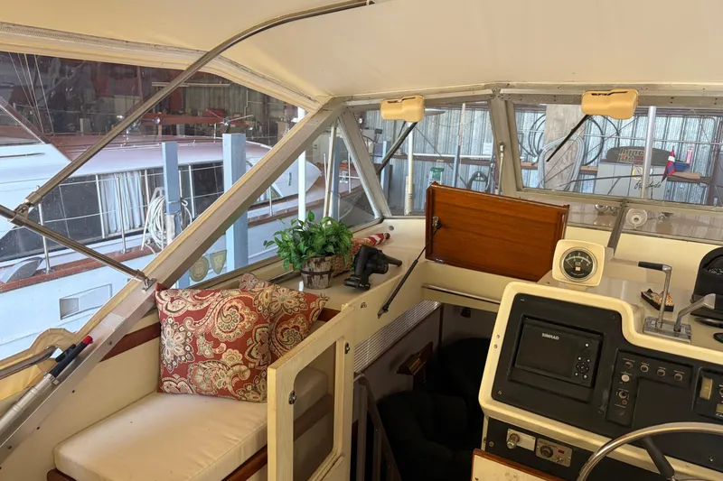 Slide: The Image of Interior of 1971 Chris-Craft 42 Commander boat with helm, seating, and decorative pillows. - 12