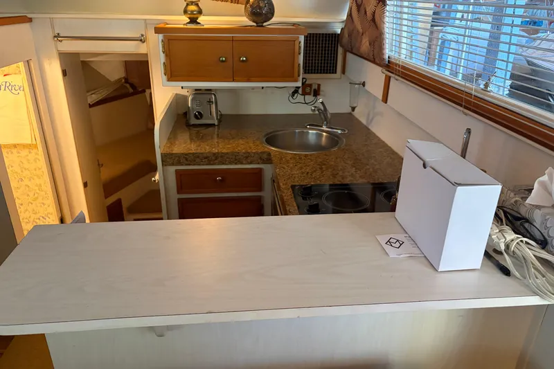 Slide: The Image of 1971 Chris-Craft 42 Commander kitchen with countertop, sink, and stove. - 15
