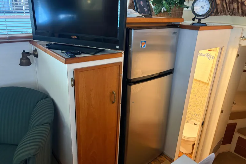 Slide: The Image of 1971 Chris-Craft 42 Commander interior with TV, fridge, and bathroom view. - 18