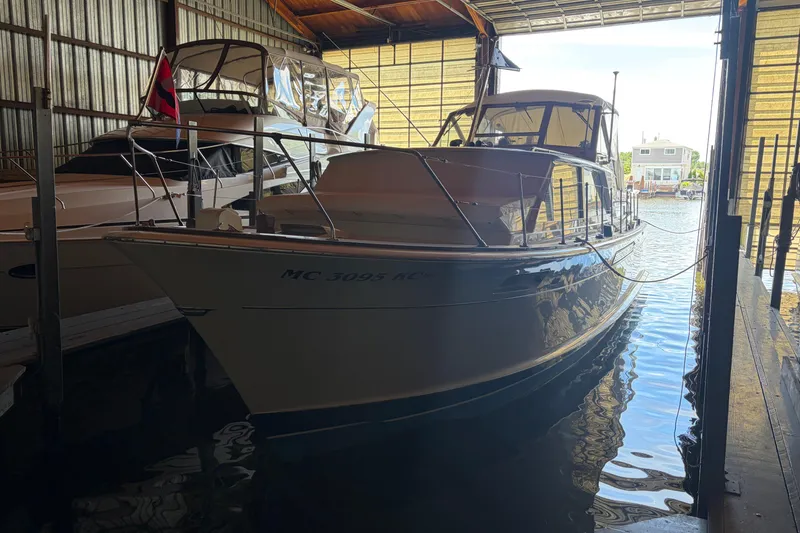 Slide: The Image of 1971 Chris-Craft 42 Commander yacht docked in a marina boathouse. - 2
