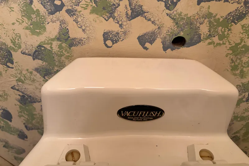 Slide: The Image of VacuFlush toilet system on 1971 Chris-Craft 42 Commander boat, with textured wall background. - 21