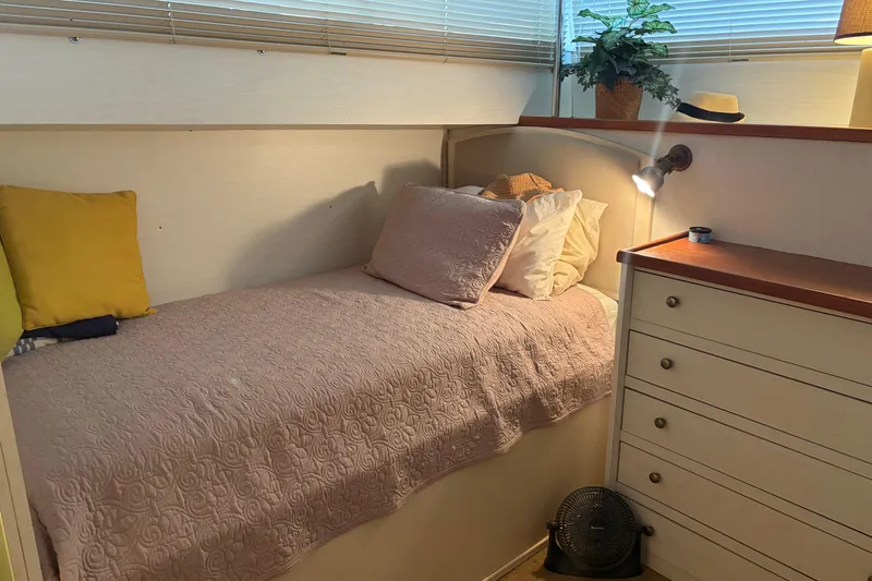 Slide: The Image of Cozy cabin interior of 1971 Chris-Craft 42 Commander with bed, pillows, and dresser. - 25