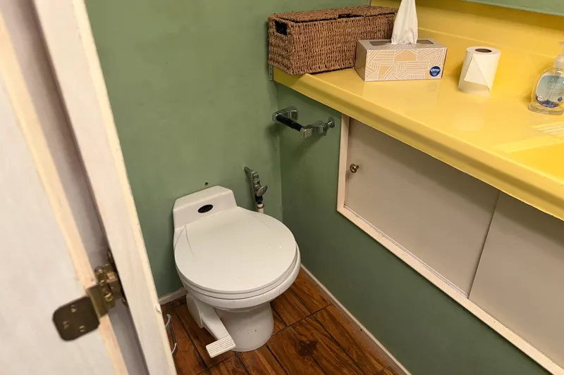 Slide: The Image of Small bathroom on 1971 Chris-Craft 42 Commander with green walls and yellow countertop. - 28