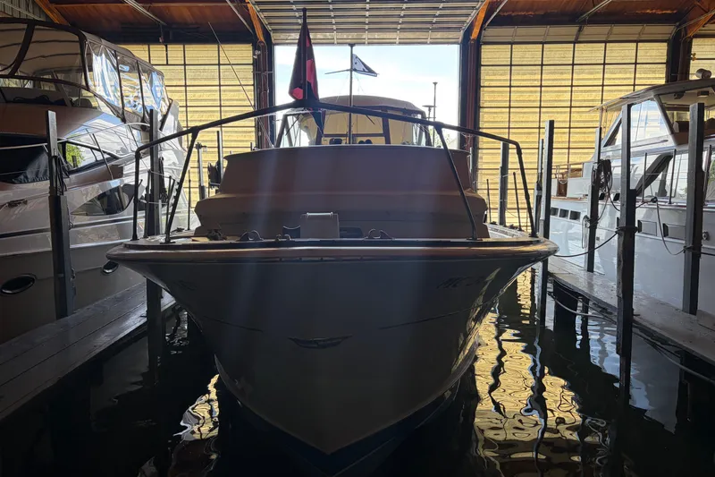 Slide: The Image of 1971 Chris-Craft 42 Commander docked in a marina, front view. - 3