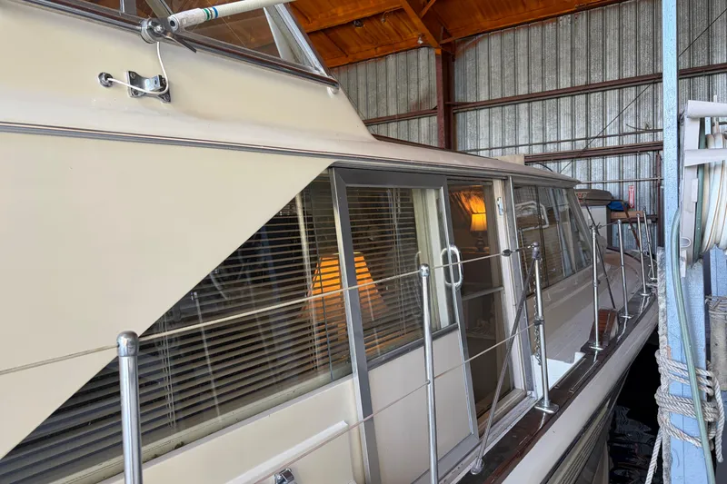 Slide: The Image of 1971 Chris-Craft 42 Commander yacht docked in a covered marina. - 7