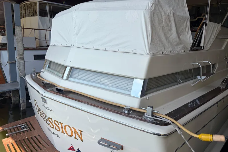 Slide: The Image of 1971 Chris-Craft 42 Commander boat docked, covered, with "Obsession" name visible. - 8