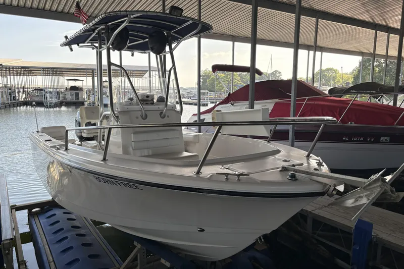 The Image of 2007 Edgewater 188CC boat docked in a marina, featuring a sleek design and sturdy build. - 0