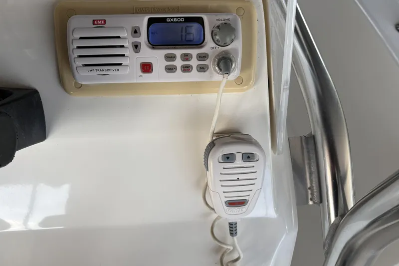 Slide: The Image of VHF transceiver on 2007 Edgewater 188CC boat dashboard with microphone attached. - 10