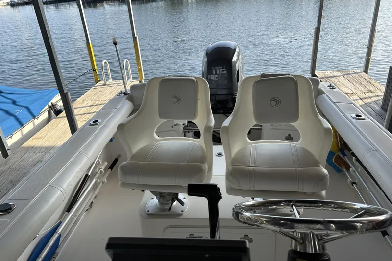 Slide: The Image of 2007 Edgewater 188CC boat interior with dual seats and Yamaha 115 engine at dock. - 11