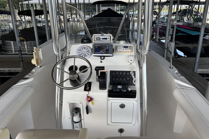 Slide: The Image of 2007 Edgewater 188CC boat console with steering wheel, controls, and navigation equipment in marina. - 4