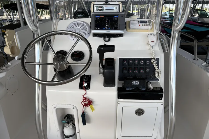 Slide: The Image of Center console of a 2007 Edgewater 188CC boat with steering wheel and controls. - 13