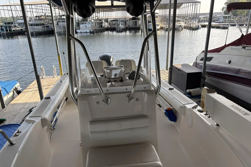 Slide: The Image of 2007 Edgewater 188CC boat docked at a marina, showcasing interior and helm. - 12