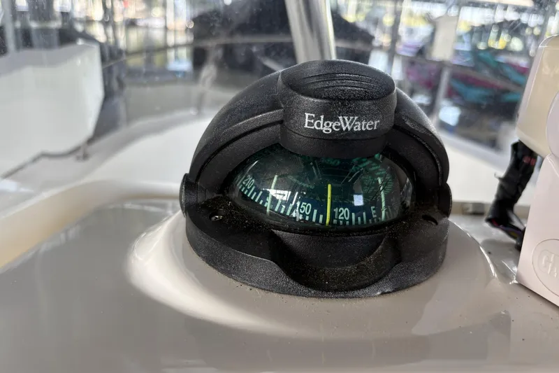 Slide: The Image of Compass on 2007 Edgewater 188CC boat dashboard, displaying navigation directions. - 7