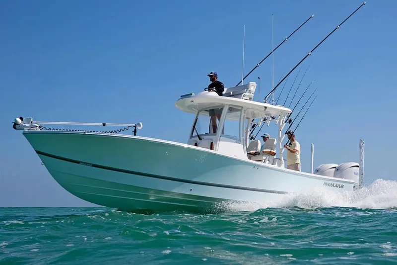 The Image of 2027 Regulator 30XO boat cruising on clear blue water with fishing rods. - 0