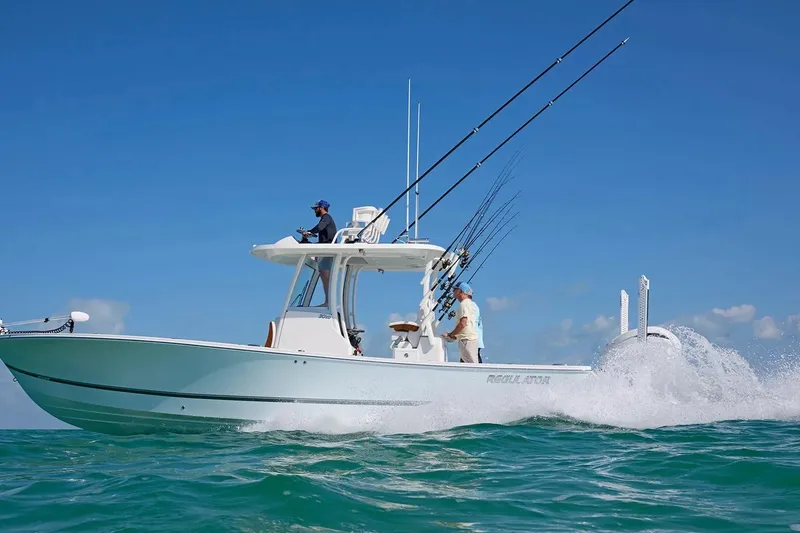 Slide: The Image of 2027 Regulator 30XO boat cruising on open water under clear blue sky. - 1