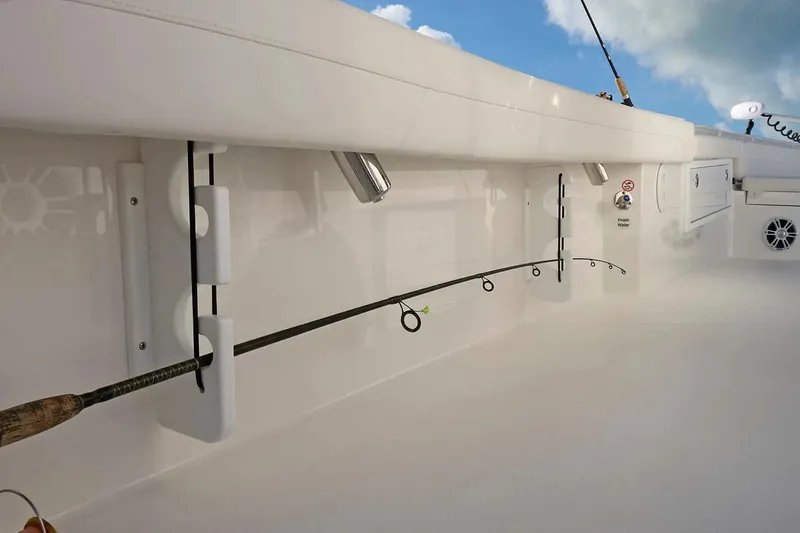 Slide: The Image of 2027 Regulator 30XO boat interior with fishing rod holders and fresh water access. - 13