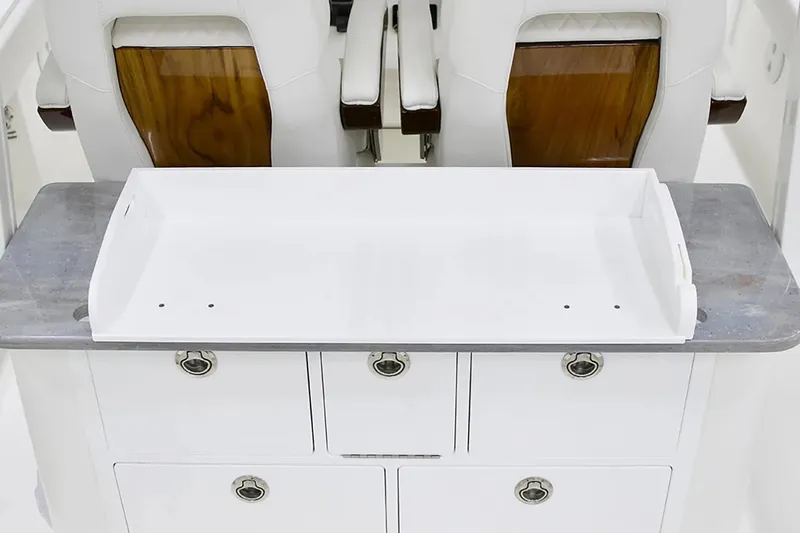 Slide: The Image of 2027 Regulator 30XO boat interior with white storage compartments and wooden accents. - 15
