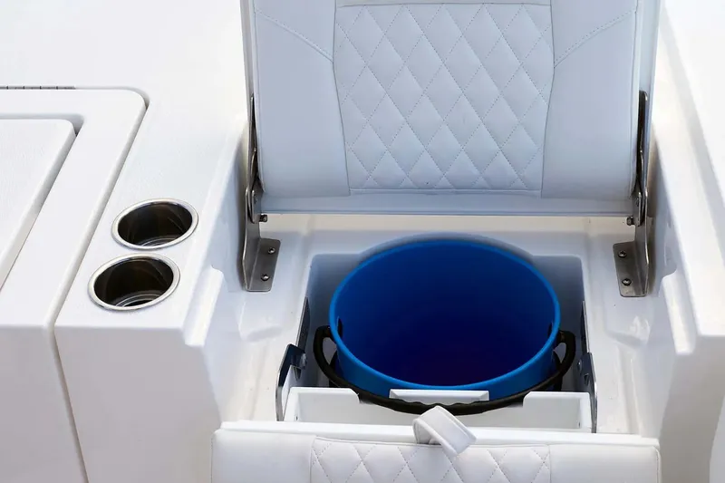 Slide: The Image of 2027 Regulator 30XO boat seat storage with blue bucket and cup holders. - 19
