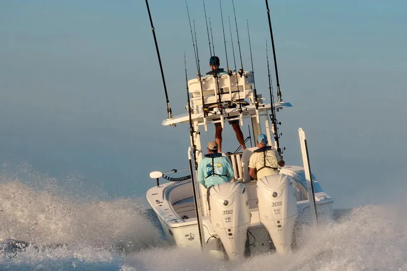 Slide: The Image of 2027 Regulator 30XO boat navigating waves with fishing rods and passengers. - 3
