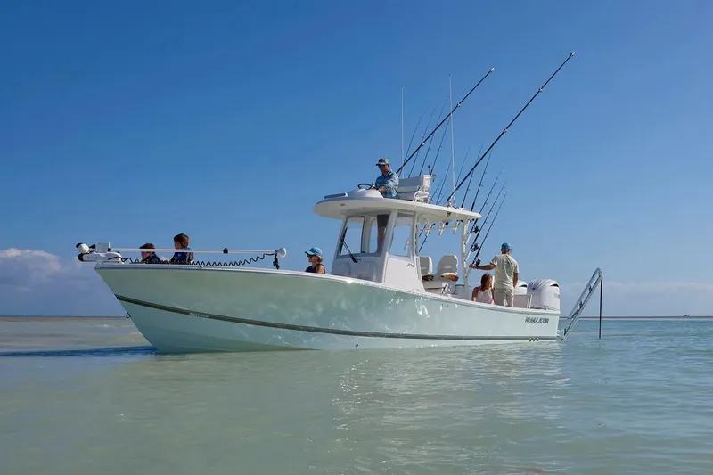 Slide: The Image of 2027 Regulator 30XO boat with fishing rods, cruising in clear waters under a blue sky. - 4
