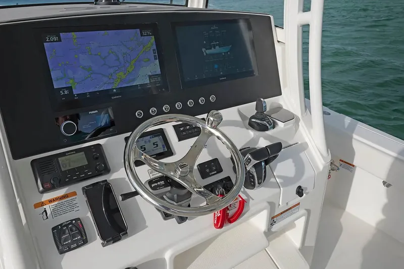 Slide: The Image of Helm of 2027 Regulator 30XO boat with advanced navigation displays and controls. - 8
