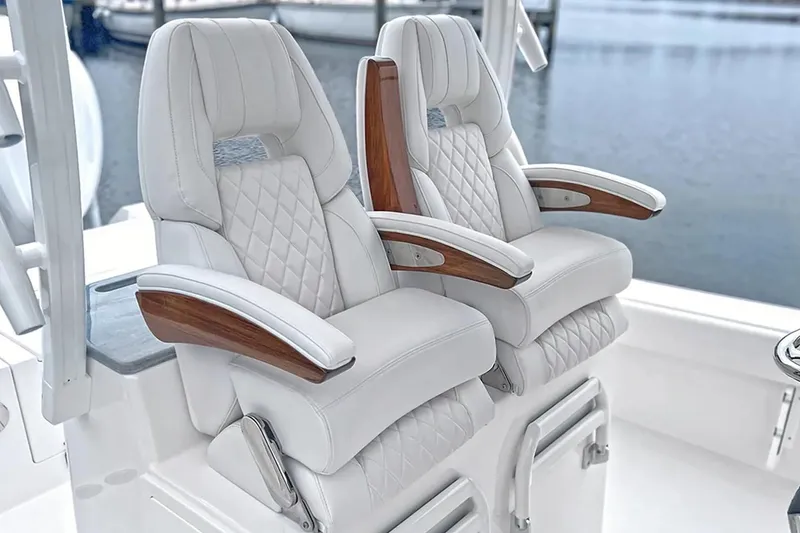 Slide: The Image of Luxurious seating on 2027 Regulator 30XO boat with quilted upholstery and wooden armrests. - 9