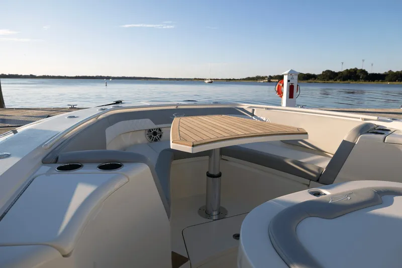 Slide: The Image of The image shows the cockpit of a 2027 Scout 357 LXF boat with a sleek wooden table. - 14