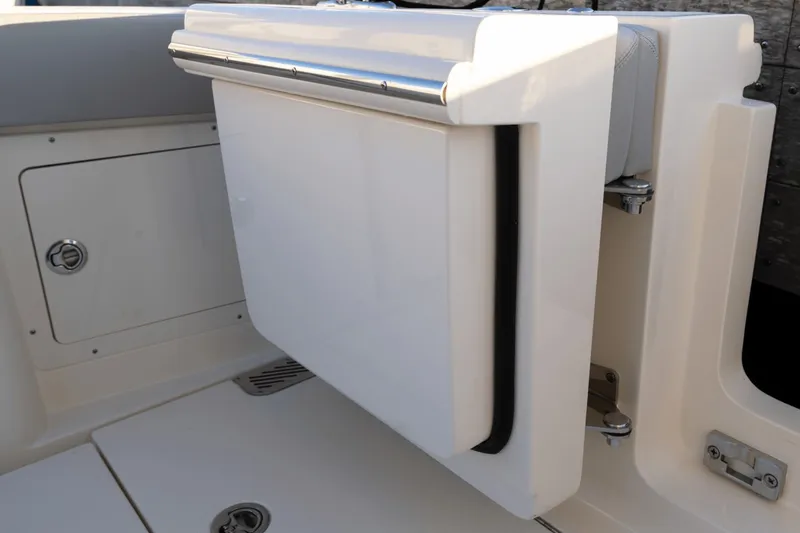 Slide: The Image of A modern white boat with a foldable seat or table in the aft area. - 40