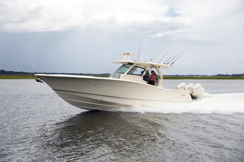 Slide: The Image of Scout 357 LXF 2027 on the water, featuring three outboard engines and fishing rods. - 3