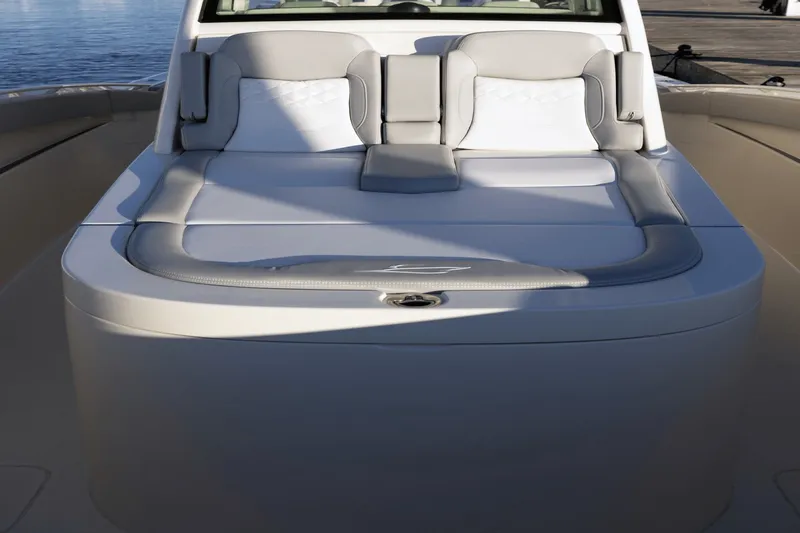 Slide: The Image of The image shows the deck of a Scout 357 LXF boat with gray and white upholstery. - 22