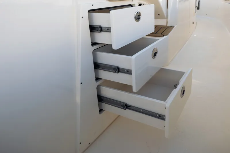 Slide: The Image of Open drawers in a boat, showing storage space and white surfaces. - 32