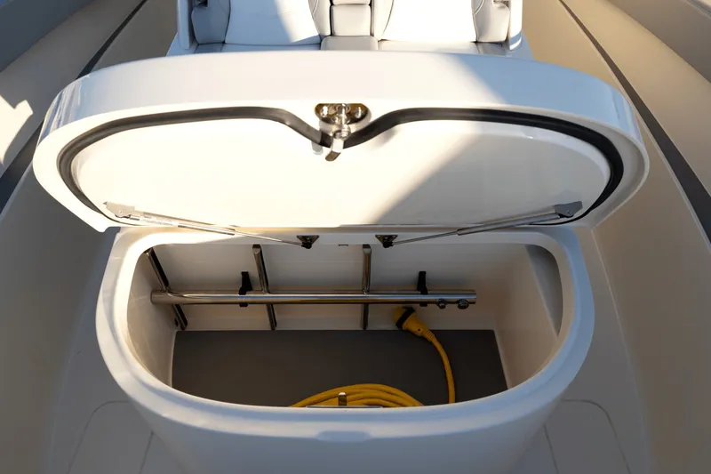 Slide: The Image of An open storage compartment on a boat with a yellow cable inside. - 24