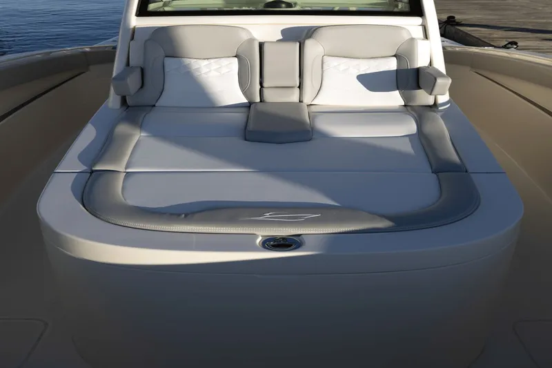 Slide: The Image of The image shows the deck of a Scout 357 LXF boat with sleek gray upholstery. - 23