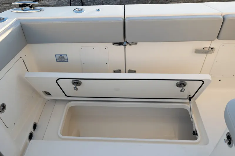 Slide: The Image of The image shows the storage compartment of a Scout 357 LXF boat with an open hatch. - 41