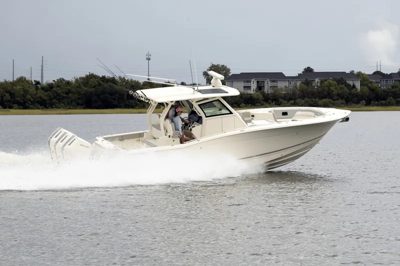 Slide: The Image of Scout 357 LXF 2027 on the water, featuring three outboard engines and a sleek design. - 6