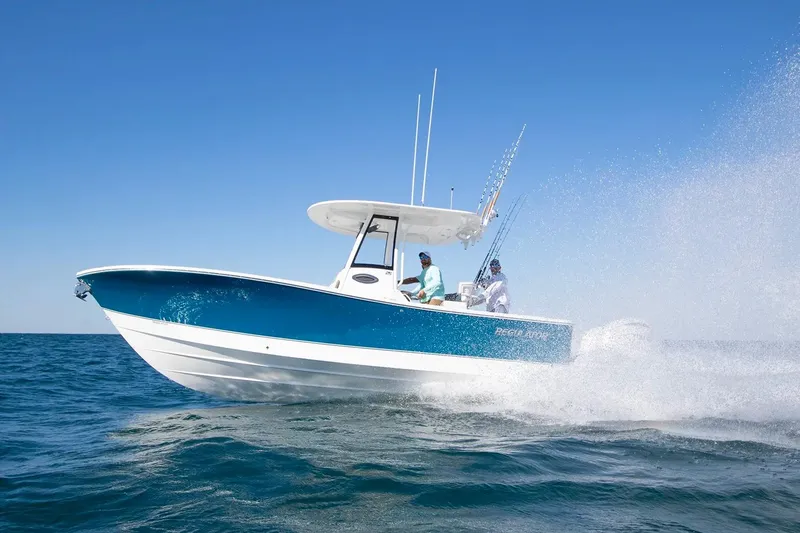 The Image of 2027 Regulator 25 boat cruising on open water under clear blue sky. - 0