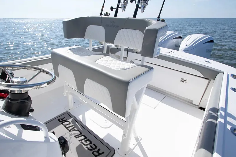 Slide: The Image of 2027 Regulator 25 boat interior with dual seating and ocean view. - 3