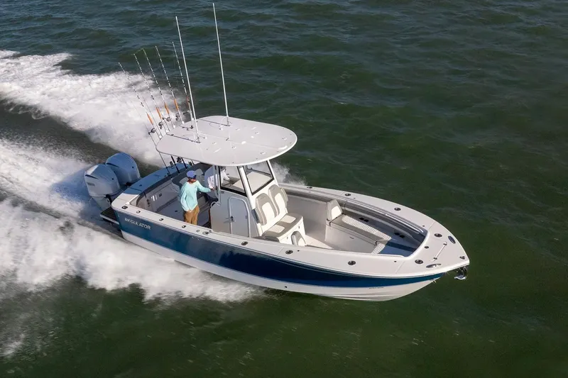 Slide: The Image of 2027 Regulator 25 boat cruising on open water with fishing rods. - 6