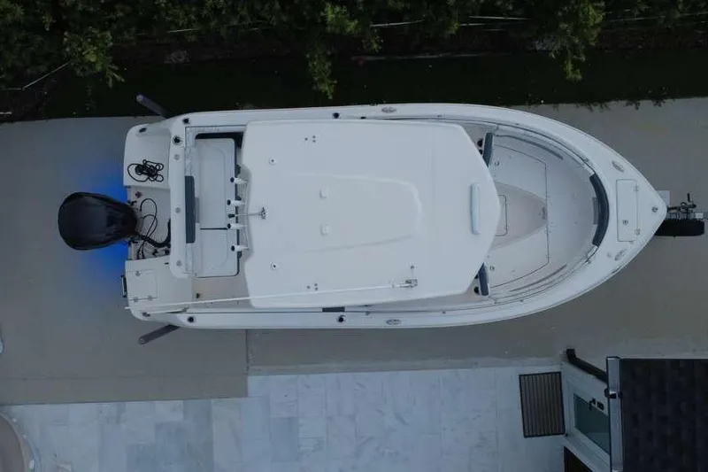 Slide: The Image of Overhead view of a 2020 Robalo R222 Explorer boat docked on a concrete surface. - 1