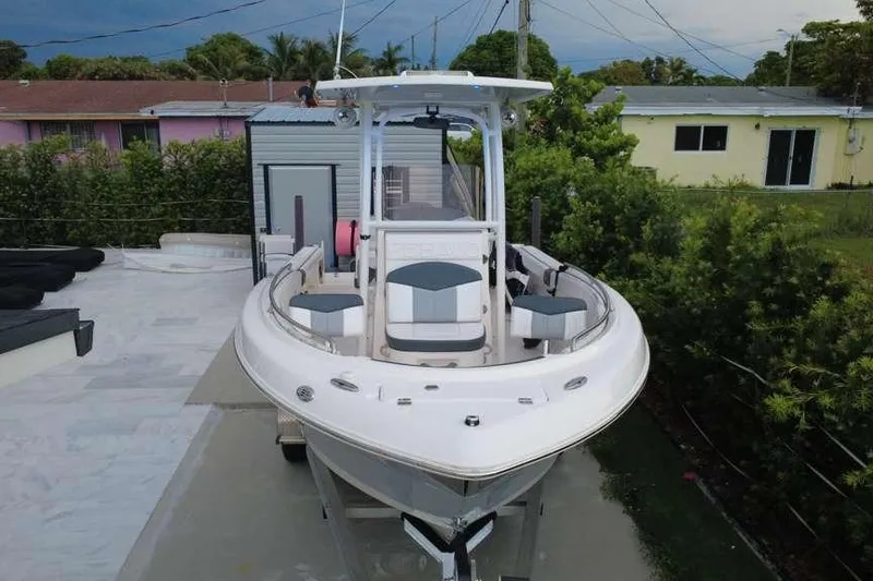 Slide: The Image of 2020 Robalo R222 Explorer boat parked in a residential driveway. - 10