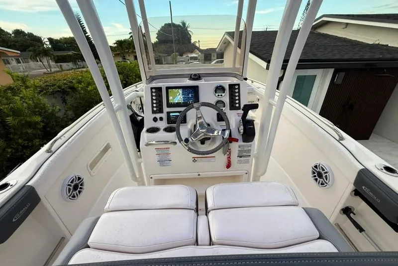 Slide: The Image of 2020 Robalo R222 Explorer boat cockpit with steering wheel and navigation system. - 13