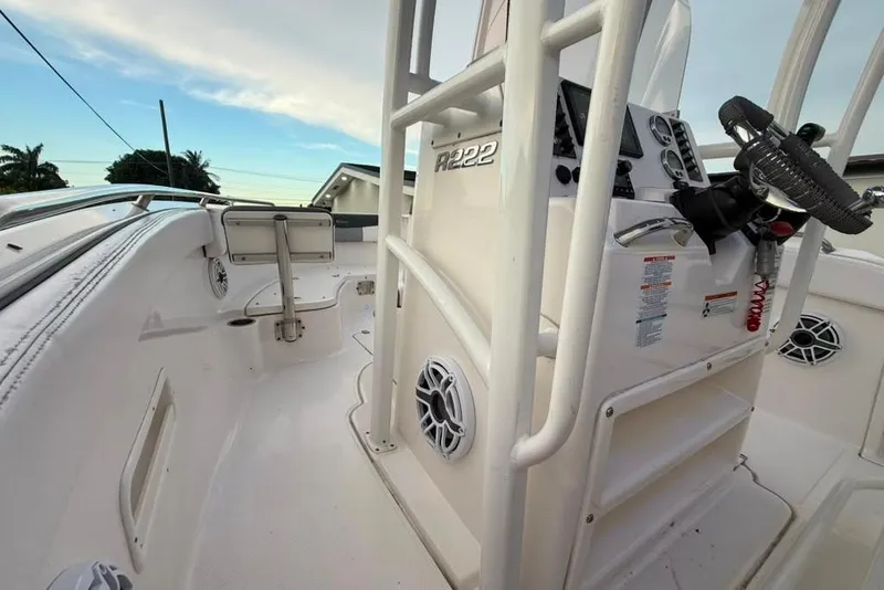 Slide: The Image of 2020 Robalo R222 Explorer boat interior with steering console and seating area. - 14