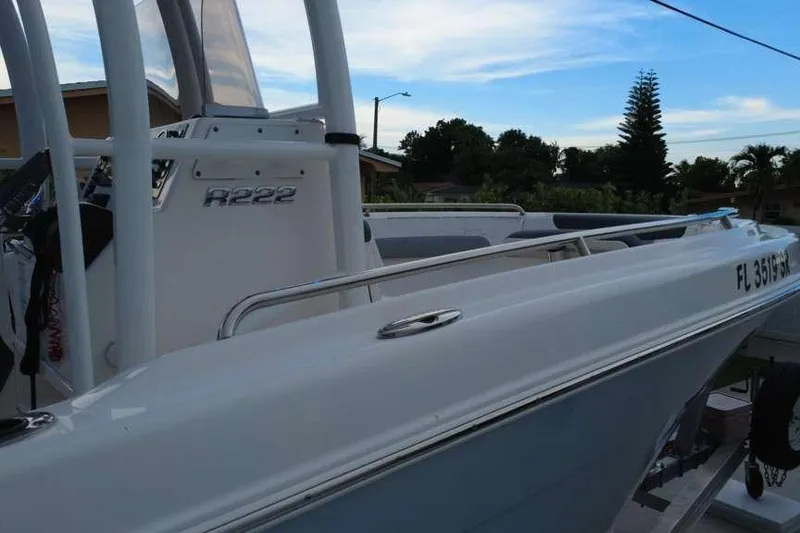 Slide: The Image of 2020 Robalo R222 Explorer boat docked, showcasing sleek design and registration number. - 15