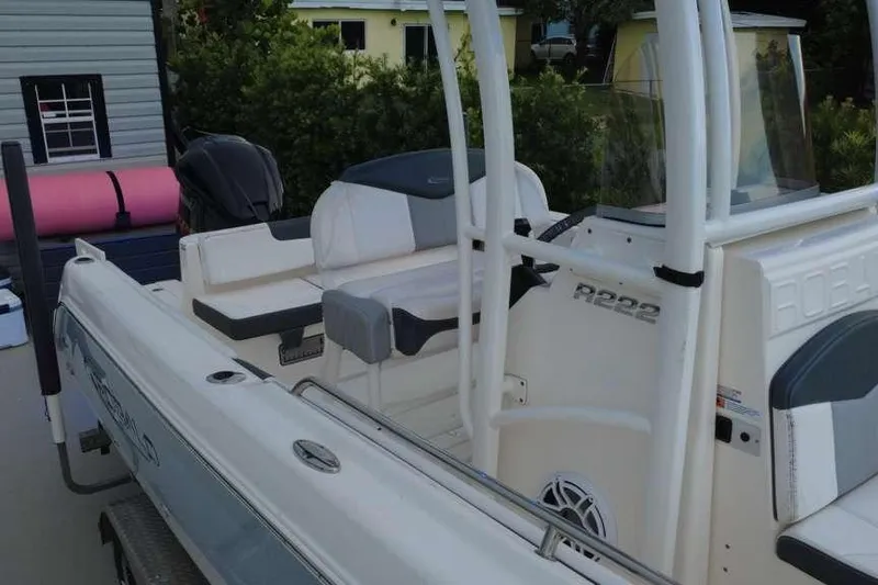 Slide: The Image of 2020 Robalo R222 Explorer boat with seating and console, parked outdoors. - 17